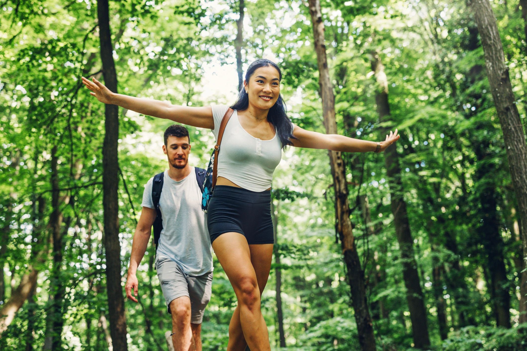 Visitors walking along a wooded park trail